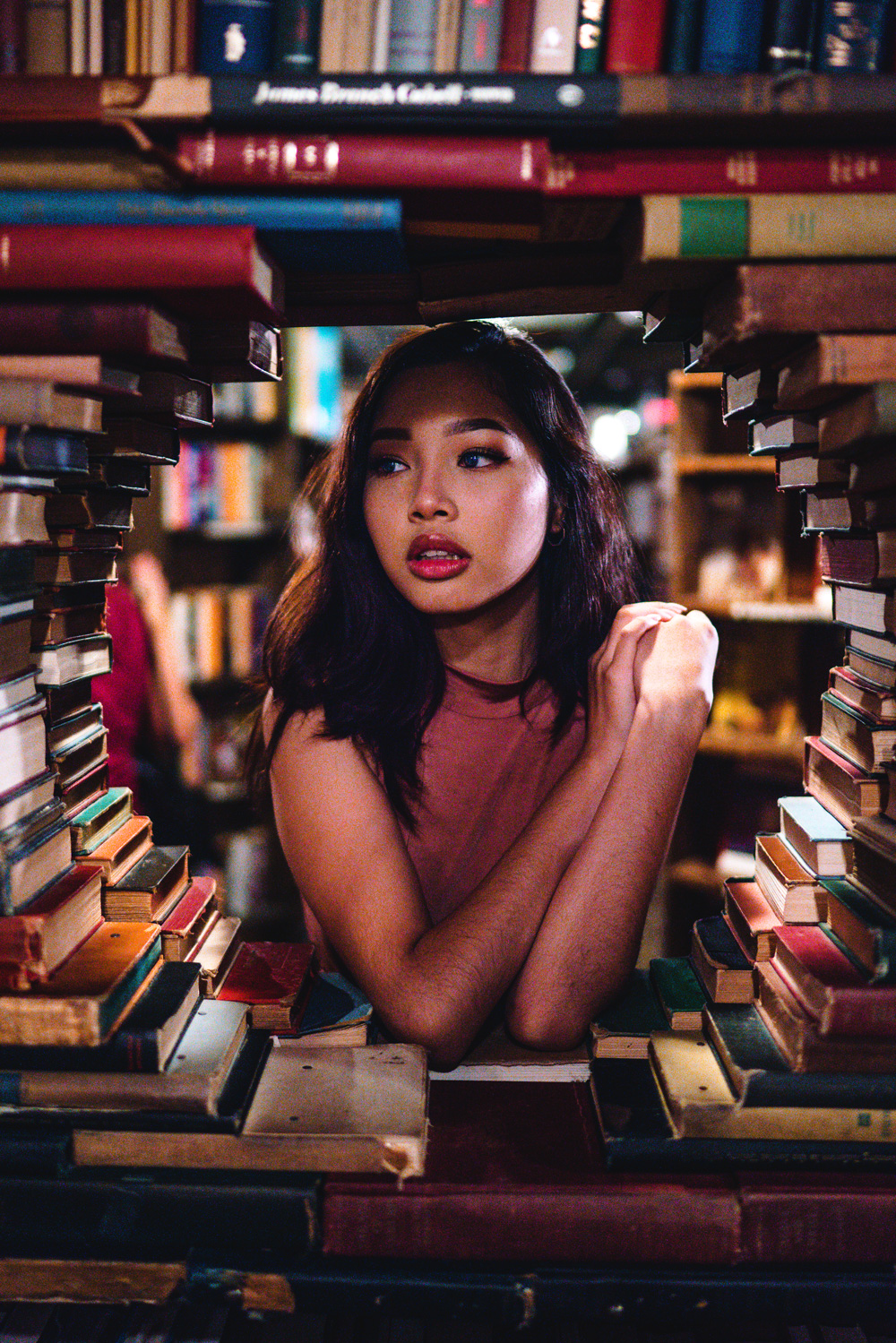 Young woman surrounded by books